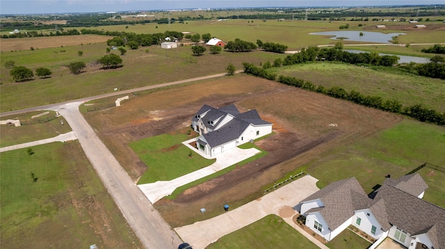 birds eye view of property with a water view and a rural view