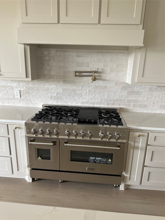 kitchen with tasteful backsplash and range with two ovens