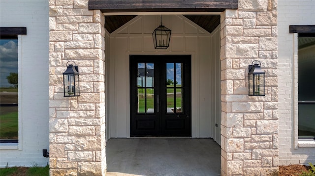 view of exterior entry featuring french doors