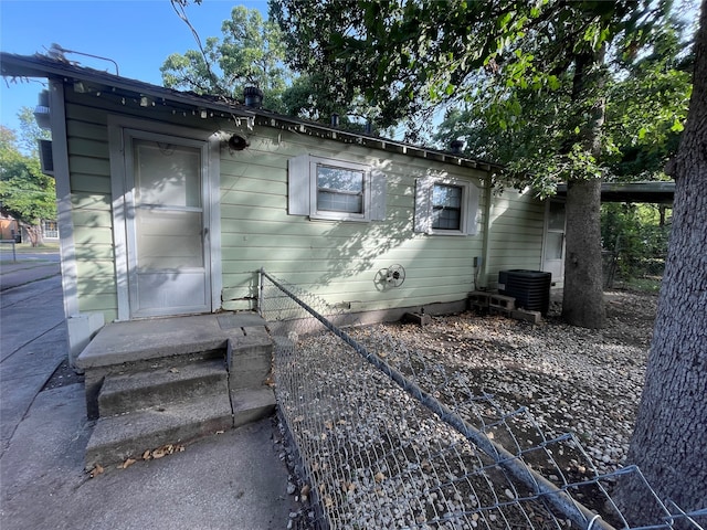 view of side of home with central AC unit