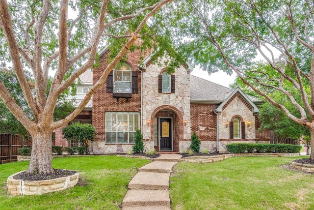 tudor house featuring a front yard