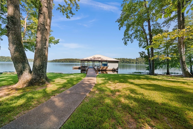 dock area with a water view and a yard