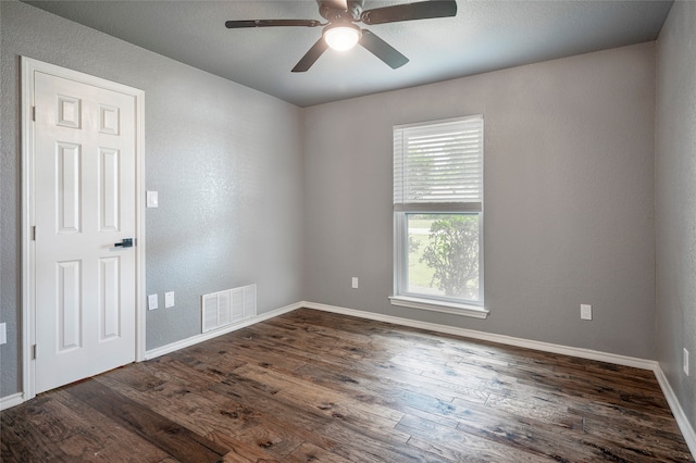 unfurnished room featuring dark hardwood / wood-style floors and ceiling fan