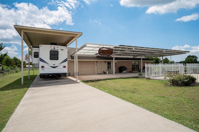 exterior space with a carport, a garage, and a lawn