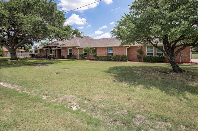 ranch-style home with a front lawn