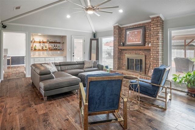 living room with ornamental molding, lofted ceiling, and a healthy amount of sunlight