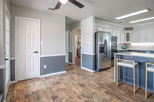 kitchen with white cabinetry, wood-type flooring, ceiling fan, and black appliances