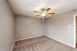 carpeted empty room featuring ceiling fan