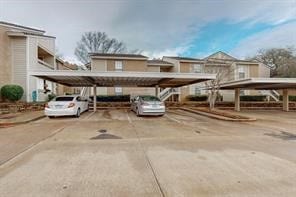 view of parking / parking lot featuring a carport