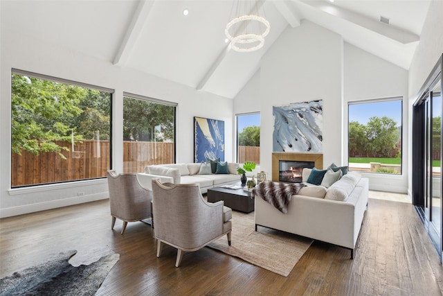 living room with dark wood-type flooring, high vaulted ceiling, beamed ceiling, and a chandelier