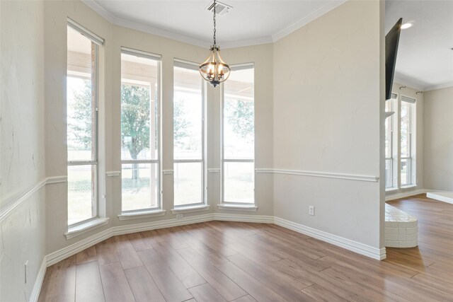 interior space with crown molding, wood-type flooring, and a wealth of natural light