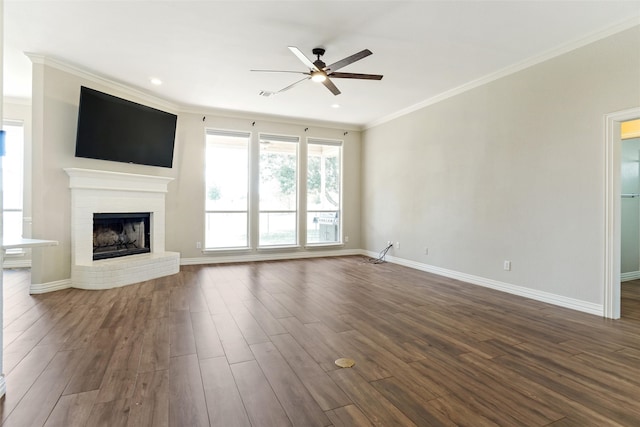 unfurnished living room featuring a fireplace, crown molding, hardwood / wood-style floors, and ceiling fan