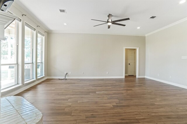 unfurnished room with a wealth of natural light, hardwood / wood-style flooring, crown molding, and ceiling fan