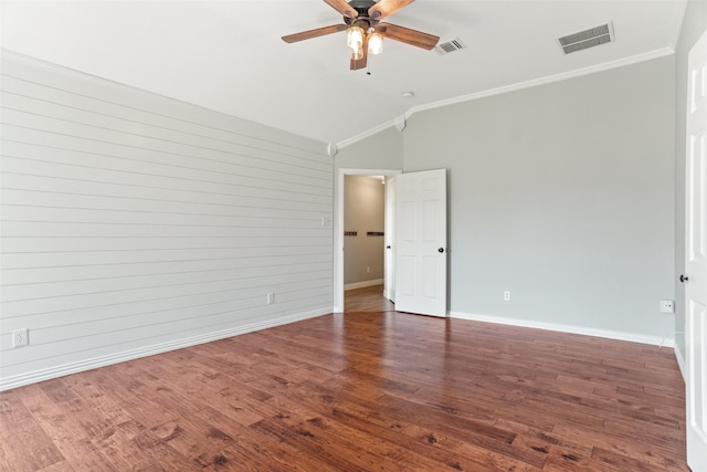 empty room featuring ornamental molding, wood-type flooring, lofted ceiling, and ceiling fan