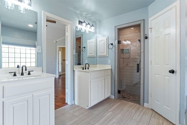 bathroom featuring walk in shower, hardwood / wood-style floors, and double sink vanity