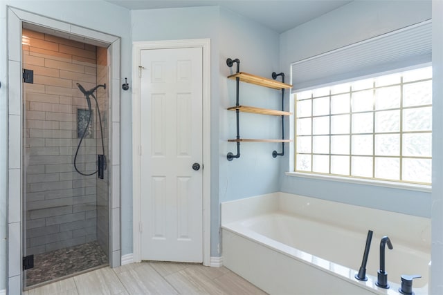 bathroom with separate shower and tub and tile patterned flooring