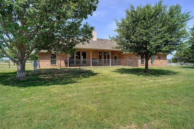 rear view of property featuring a yard