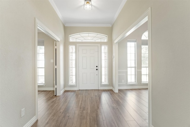 entryway featuring hardwood / wood-style floors and ornamental molding