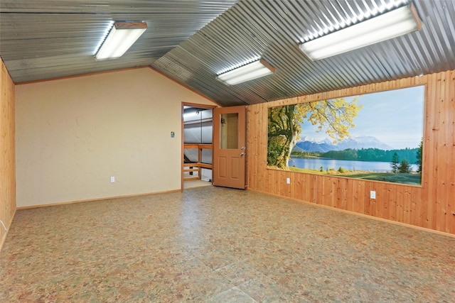 tiled empty room with wood walls and a water and mountain view