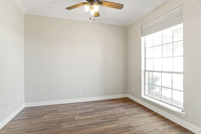 empty room featuring ornamental molding, ceiling fan, and hardwood / wood-style floors