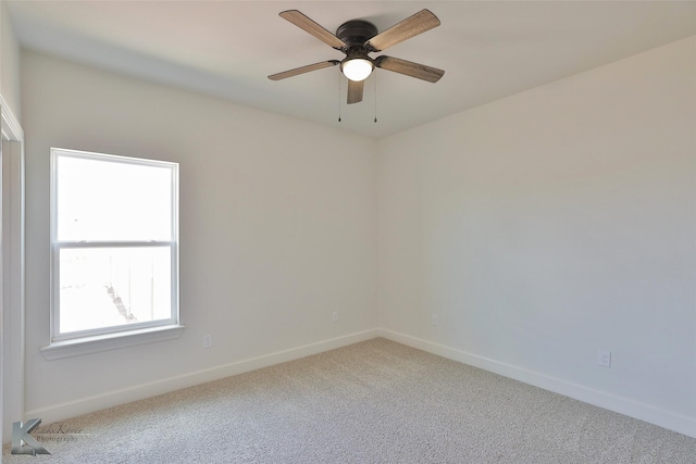 empty room with a ceiling fan, baseboards, and carpet flooring