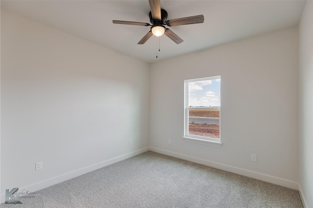 empty room with a ceiling fan, carpet flooring, and baseboards