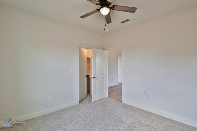 unfurnished room featuring light carpet, ceiling fan, visible vents, and baseboards