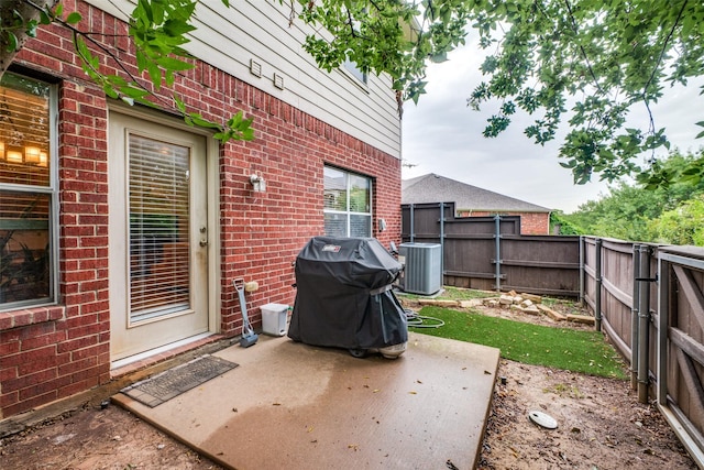 view of patio with a grill and central AC unit