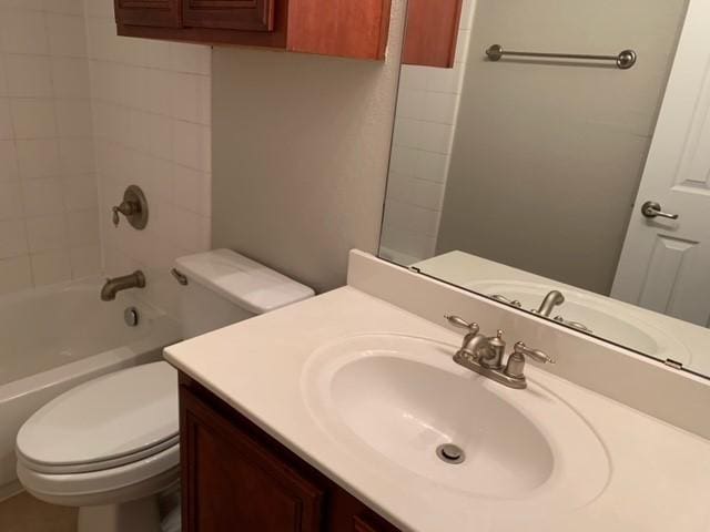 full bathroom featuring vanity, toilet, and tiled shower / bath