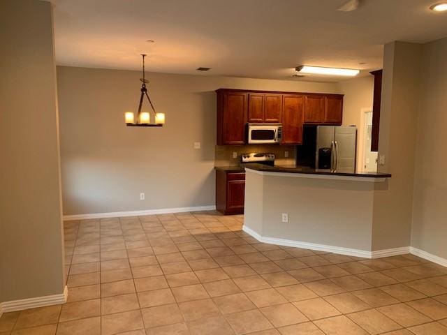 kitchen featuring decorative light fixtures, light tile patterned floors, appliances with stainless steel finishes, a notable chandelier, and kitchen peninsula