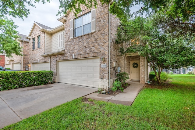 view of property featuring a garage and a front lawn