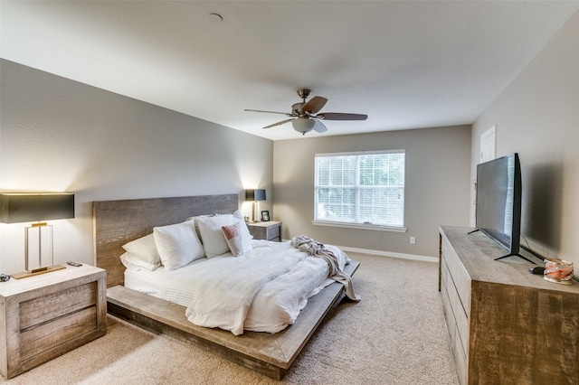 bedroom with light carpet and ceiling fan