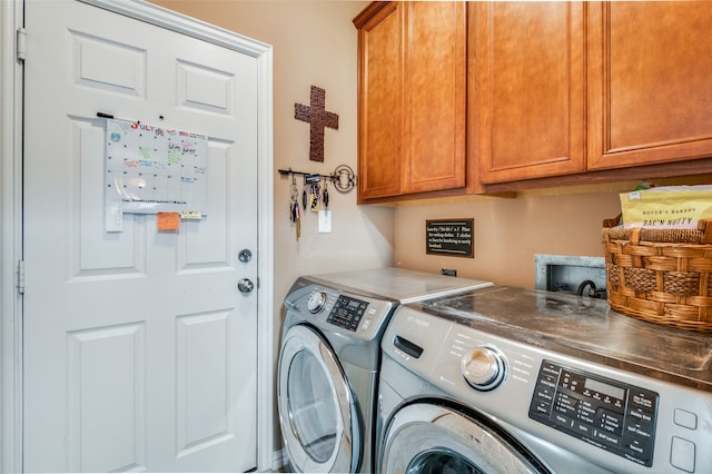 laundry area with cabinets and washing machine and clothes dryer