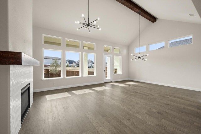 unfurnished living room with a chandelier, beamed ceiling, high vaulted ceiling, dark hardwood / wood-style floors, and a fireplace