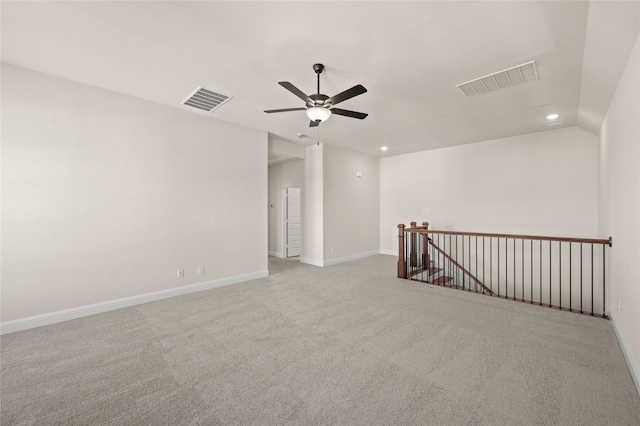 carpeted spare room with vaulted ceiling and ceiling fan