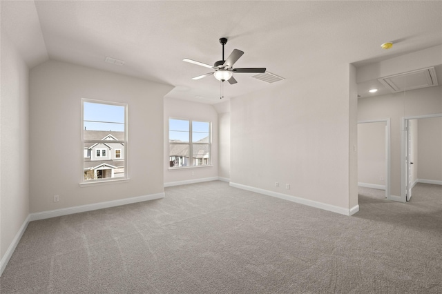 carpeted empty room with vaulted ceiling and ceiling fan