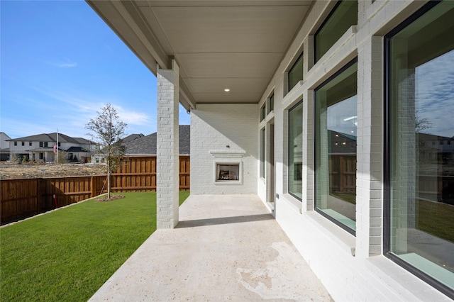 view of patio featuring an outdoor brick fireplace