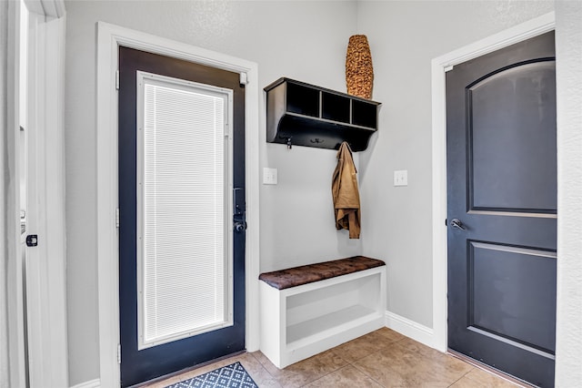 mudroom featuring light tile patterned floors and baseboards