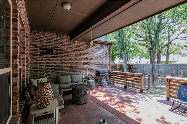 view of patio featuring a grill, fence, and an outdoor hangout area