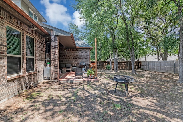 view of yard featuring fence private yard, an outdoor fire pit, and a wooden deck