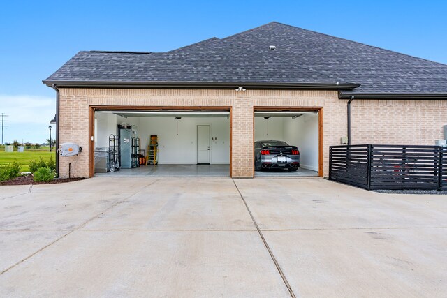 view of side of home with a garage and water heater