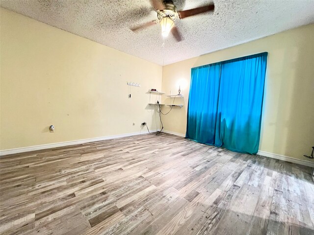 unfurnished bedroom with hardwood / wood-style flooring, ceiling fan, and a textured ceiling