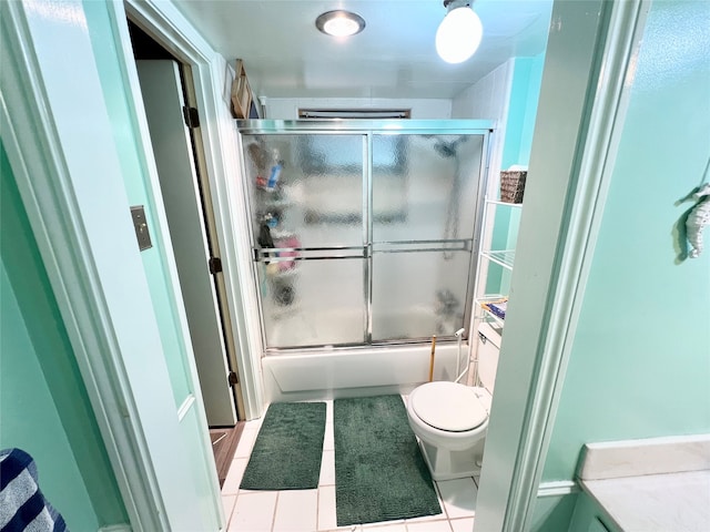 full bathroom featuring tile patterned floors, toilet, combined bath / shower with glass door, and vanity