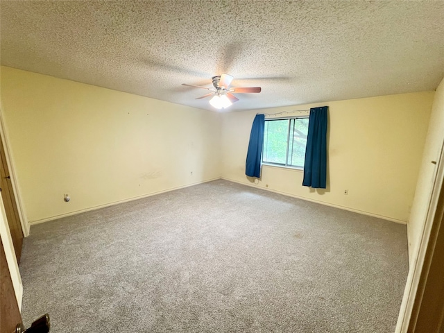 empty room featuring carpet flooring, ceiling fan, and a textured ceiling