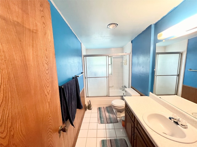 full bathroom with tile patterned floors, vanity, toilet, and shower / bath combination with glass door