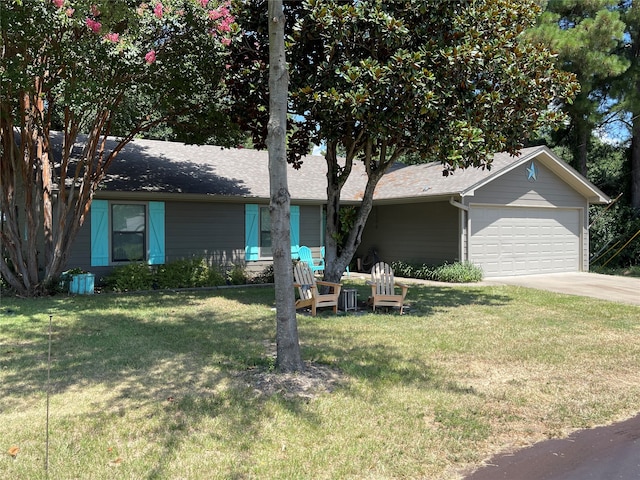 single story home featuring a garage and a front yard