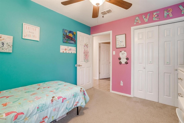 carpeted bedroom featuring ceiling fan and a closet