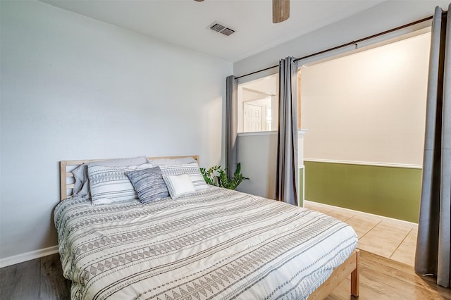 bedroom with hardwood / wood-style flooring and ceiling fan