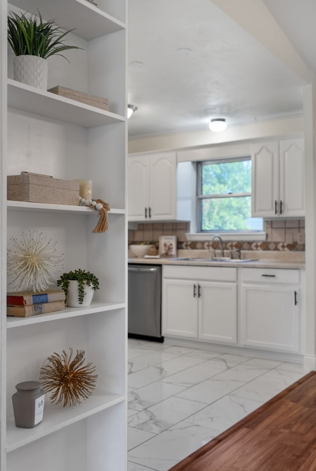 kitchen featuring backsplash, white cabinetry, and dishwasher