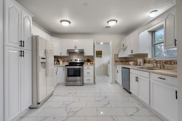 kitchen featuring tasteful backsplash, sink, crown molding, appliances with stainless steel finishes, and white cabinets